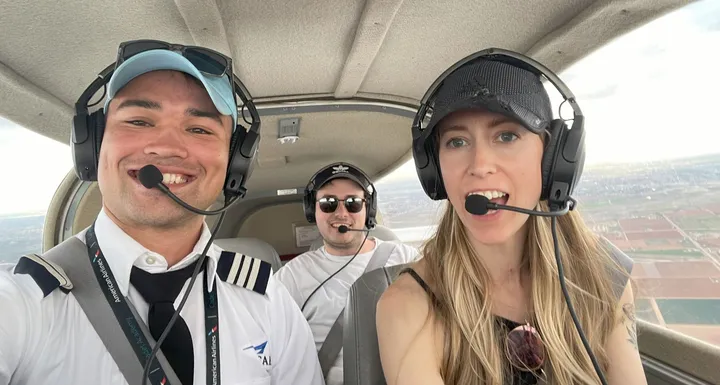 Passengers wearing aviation headsets during helicopter flight