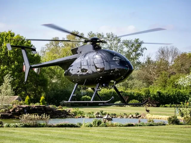 Modern twin-engine helicopter in flight over Tanzania landscape