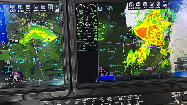 Pilot reviewing real-time weather radar and satellite on tablet