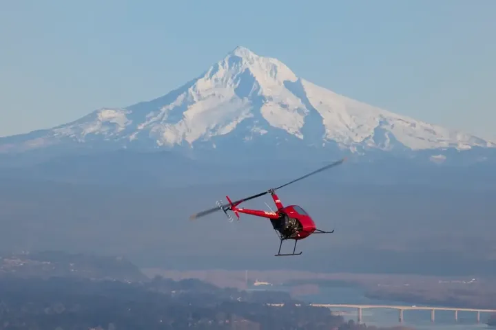 Helicopter in flight demonstrating long-range capabilities over landscape