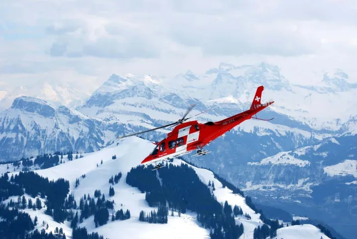 Helicopter flying high above mountains demonstrating altitude capability