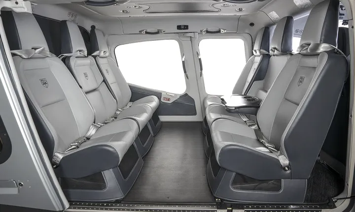 Group of passengers in comfortable helicopter cabin during flight