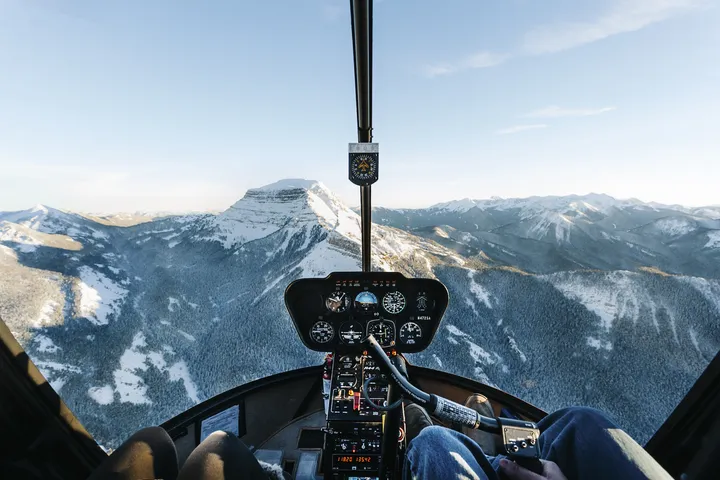 Helicopter cruising at speed over scenic landscape