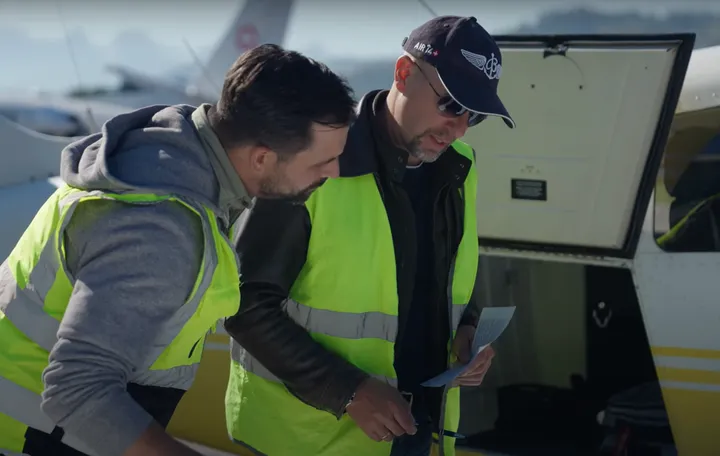 Passengers boarding helicopter with safety briefing for medical considerations